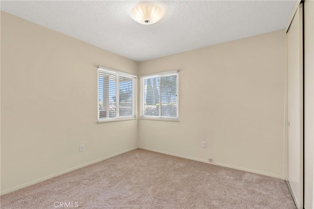8751 Oasis Ave, Westminster, CA 92683 - unfurnished room with light carpet, baseboards, and a textured ceiling