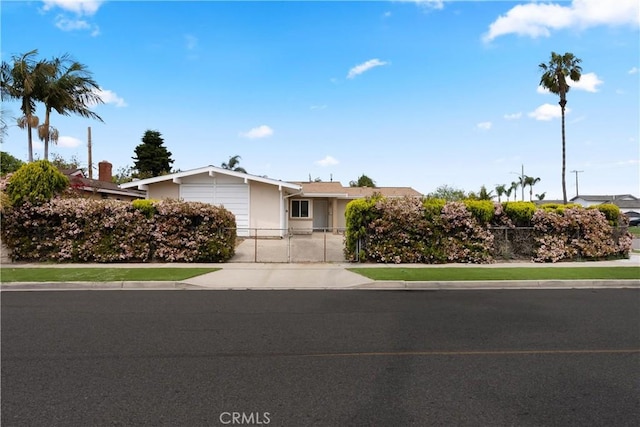 8751 Oasis Ave, Westminster, CA 92683 - single story home featuring an attached garage, concrete driveway, fence, and a gate