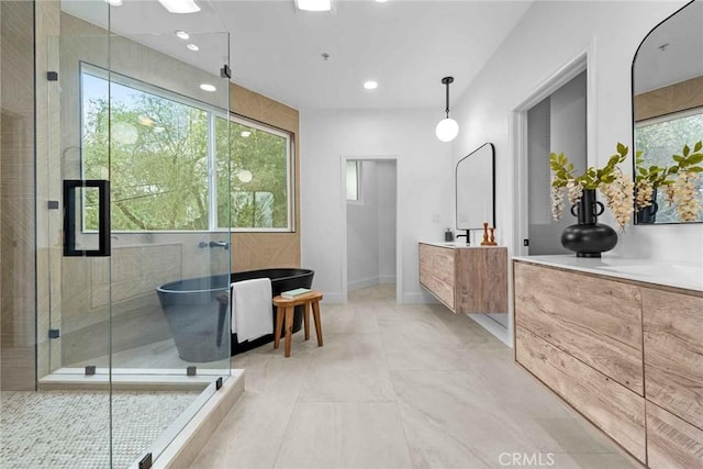 9027 Wonderland Ave, Los Angeles, CA 90046 - bathroom with a freestanding tub, vanity, a stall shower, recessed lighting, and baseboards