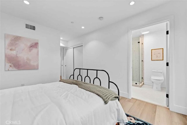 9027 Wonderland Ave, Los Angeles, CA 90046 - bedroom with wood finished floors, recessed lighting, ensuite bathroom, and a closet