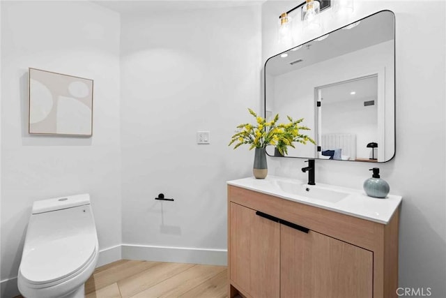 9027 Wonderland Ave, Los Angeles, CA 90046 - bathroom featuring vanity, wood finished floors, baseboards, and toilet