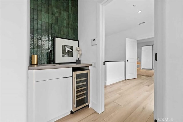 9027 Wonderland Ave, Los Angeles, CA 90046 - indoor dry bar with beverage cooler, light wood-style floors, recessed lighting, and baseboards