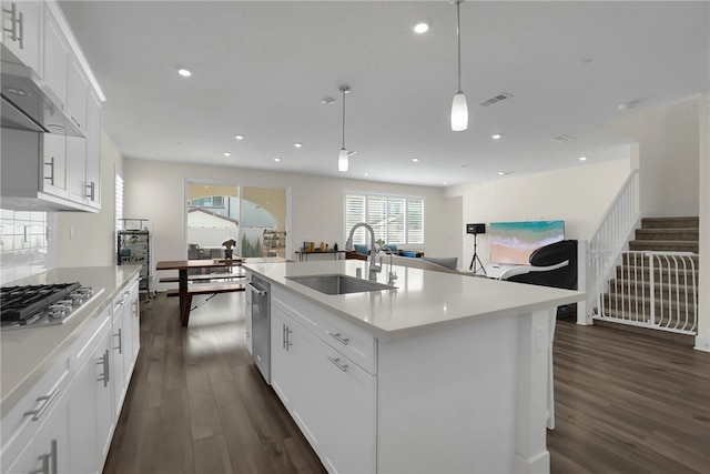 16533 Ground Breaker Ave, Chino, CA 91708 - kitchen with wall chimney exhaust hood, a sink, dark wood-style floors, and stainless steel appliances