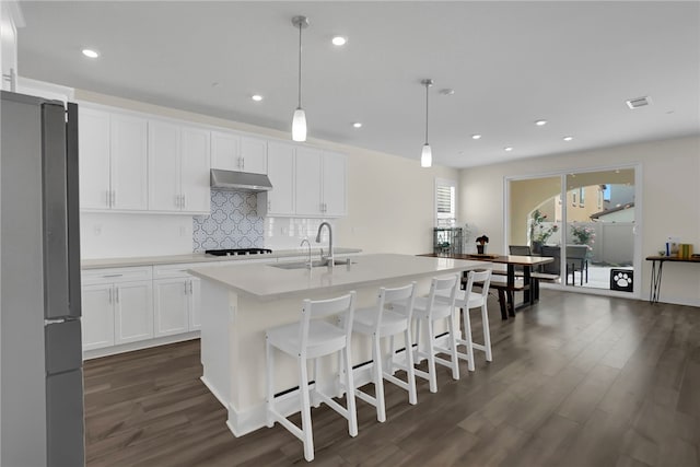 16533 Ground Breaker Ave, Chino, CA 91708 - kitchen featuring a sink, dark wood-style flooring, freestanding refrigerator, under cabinet range hood, and decorative backsplash