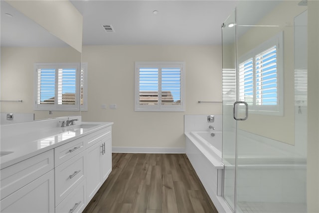 16533 Ground Breaker Ave, Chino, CA 91708 - full bathroom with baseboards, a sink, double vanity, wood finished floors, and a stall shower