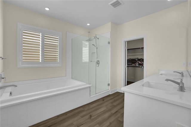 16533 Ground Breaker Ave, Chino, CA 91708 - bathroom featuring a garden tub, a shower stall, visible vents, wood finished floors, and a sink