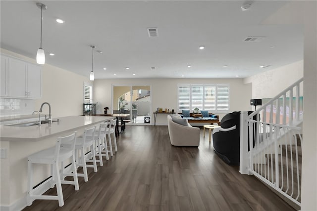 16533 Ground Breaker Ave, Chino, CA 91708 - living area with stairway, dark wood-style floors, visible vents, and recessed lighting