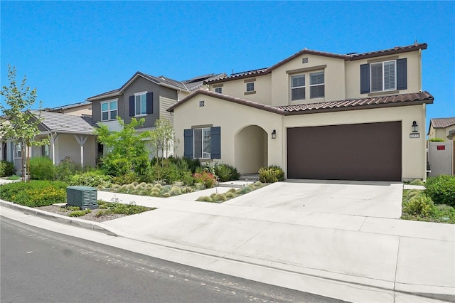 16533 Ground Breaker Ave, Chino, CA 91708 - mediterranean / spanish home featuring driveway, a tiled roof, an attached garage, and stucco siding