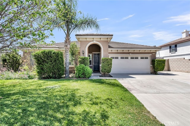 16569 Sugar Ln, Fontana, CA 92337 - mediterranean / spanish-style home with a garage, stucco siding, concrete driveway, and a front yard
