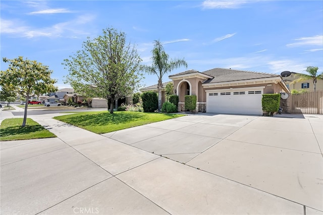 16569 Sugar Ln, Fontana, CA 92337 - view of front of property featuring an attached garage, concrete driveway, stucco siding, stone siding, and a tiled roof