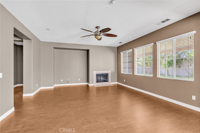 16569 Sugar Ln, Fontana, CA 92337 - unfurnished living room featuring ceiling fan, baseboards, a tile fireplace, and light wood finished floors