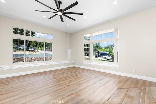 unfurnished room with baseboards, recessed lighting, wood finished floors, and a ceiling fan