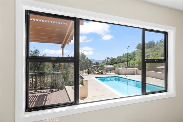 view of swimming pool with a mountain view