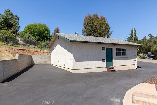 view of home's exterior featuring fence, a patio area, entry steps, and stucco siding