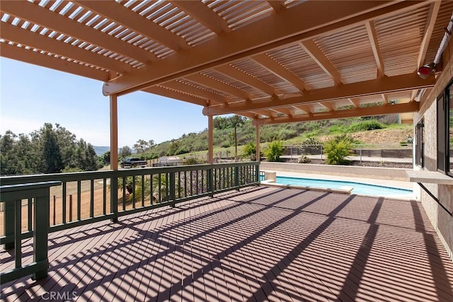 wooden terrace featuring an outdoor pool, fence, and a pergola
