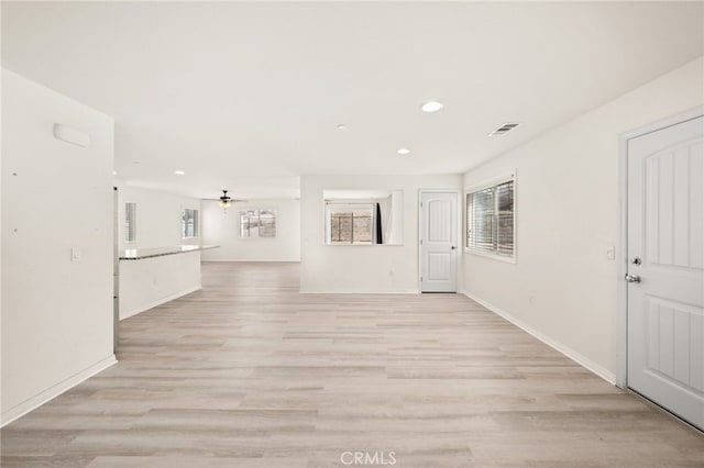 unfurnished living room featuring light wood-type flooring, a ceiling fan, visible vents, and recessed lighting