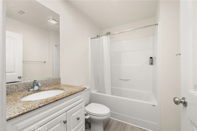 bathroom featuring toilet, visible vents, shower / tub combo, wood finished floors, and vanity