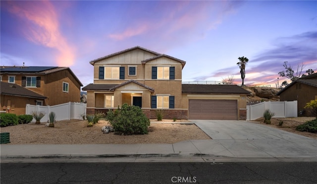 view of front facade featuring fence, stucco siding, a garage, and concrete driveway