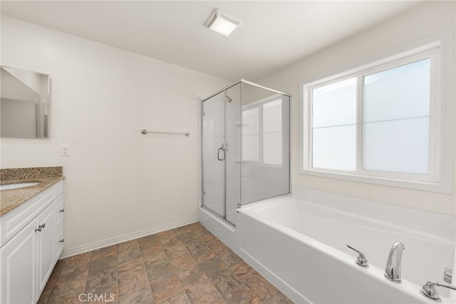 bathroom featuring vanity, baseboards, a garden tub, and a stall shower