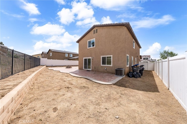 rear view of property with central air condition unit, a fenced backyard, a patio, and stucco siding