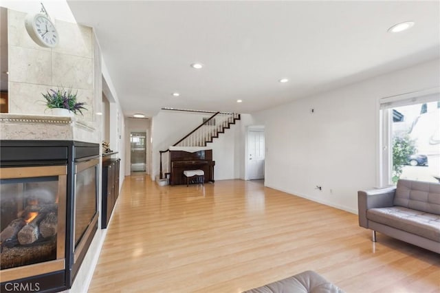 2652 La Salle Way, San Jose, CA 95130 - living area featuring light wood-style flooring, a multi sided fireplace, recessed lighting, baseboards, and stairs