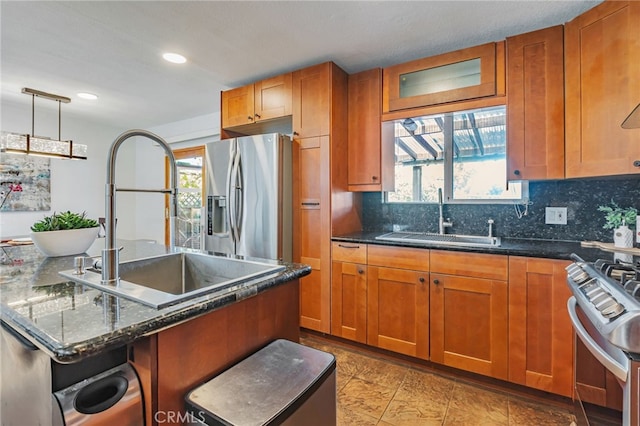 2652 La Salle Way, San Jose, CA 95130 - kitchen featuring appliances with stainless steel finishes, brown cabinets, decorative backsplash, recessed lighting, and dark stone counters