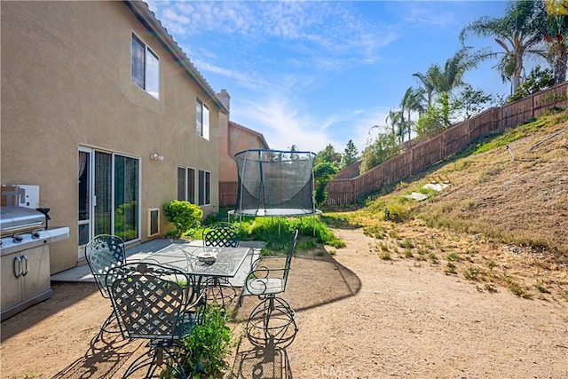25382 Silverwood Ln, Menifee, CA 92584 - view of yard with a trampoline, a patio area, and outdoor dining space