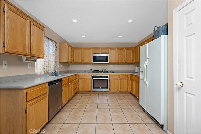 25382 Silverwood Ln, Menifee, CA 92584 - kitchen featuring appliances with stainless steel finishes, light tile patterned floors, light countertops, and recessed lighting