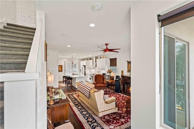 19533 Cardigan Dr, Northridge, CA 91324 - living area with a glass covered fireplace, recessed lighting, stairway, a ceiling fan, and wood finished floors