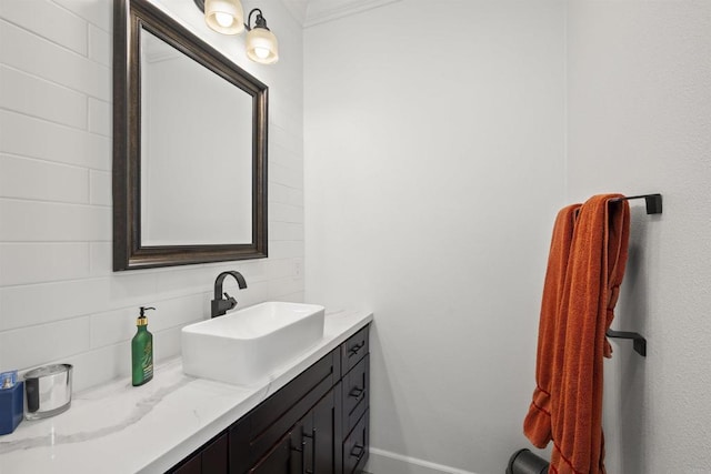 bathroom featuring backsplash, baseboards, and vanity