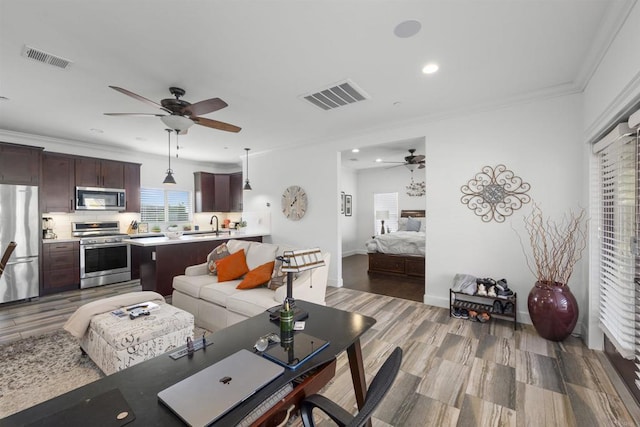 living room with recessed lighting, ceiling fan, and visible vents