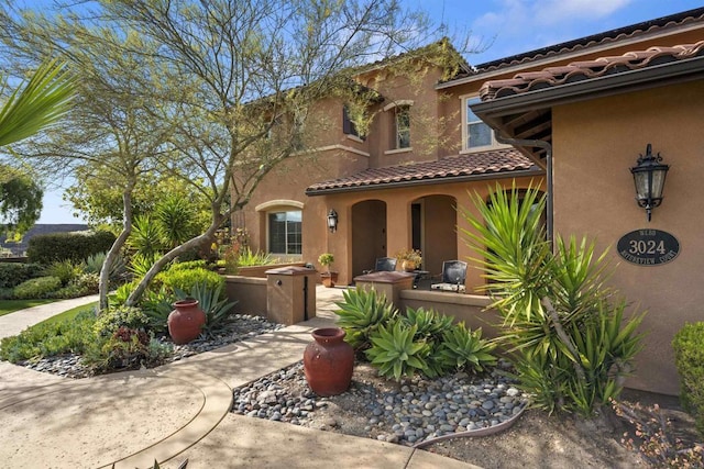 view of front of home with stucco siding and a tile roof