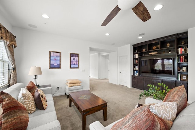 living area featuring a ceiling fan, baseboards, recessed lighting, and light carpet