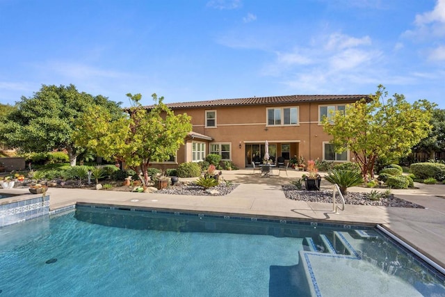 outdoor pool with a patio area