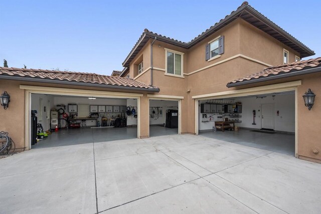 3024 Natureview Ct, Chula Vista, CA 91914 - rear view of property with concrete driveway, a garage, a tiled roof, and stucco siding