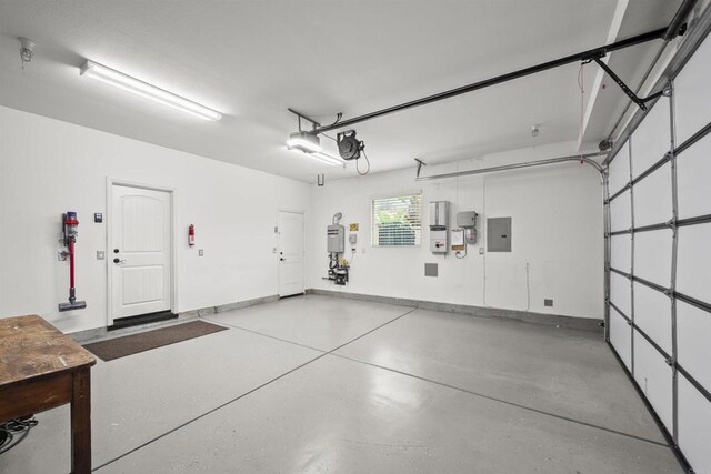 3024 Natureview Ct, Chula Vista, CA 91914 - garage with electric panel, a garage door opener, and baseboards
