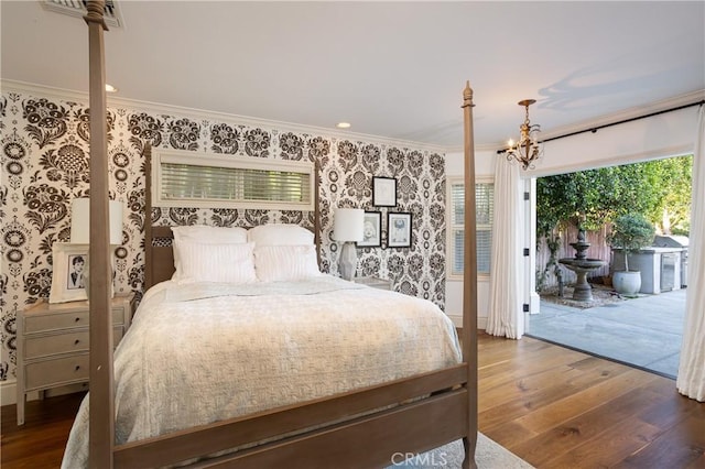bedroom with hardwood / wood-style flooring, access to exterior, wallpapered walls, and ornamental molding