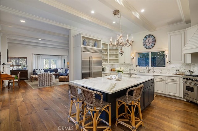 2400 Holly Ln, Newport Beach, CA 92663 - kitchen featuring high end appliances, dark wood finished floors, light stone countertops, decorative backsplash, and ornamental molding