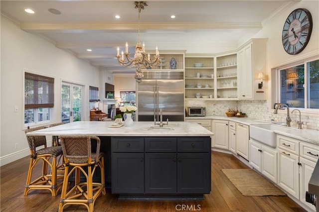 2400 Holly Ln, Newport Beach, CA 92663 - kitchen with stainless steel built in fridge, a sink, tasteful backsplash, an island with sink, and beamed ceiling