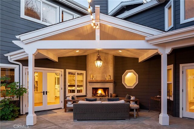 view of patio / terrace featuring french doors and an outdoor living space with a fireplace