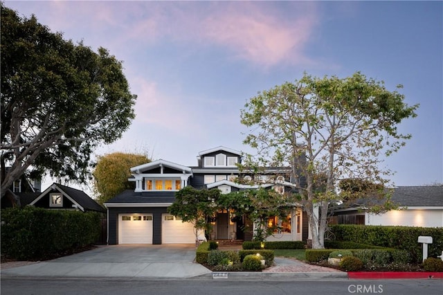 view of front facade featuring concrete driveway and a garage