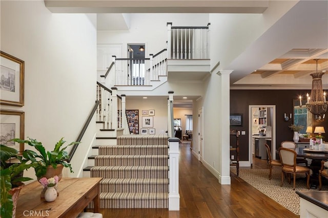 2400 Holly Ln, Newport Beach, CA 92663 - stairway featuring hardwood / wood-style floors, coffered ceiling, crown molding, a chandelier, and beamed ceiling