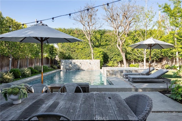 view of pool featuring a fenced in pool, a patio area, a fenced backyard, and outdoor dining space