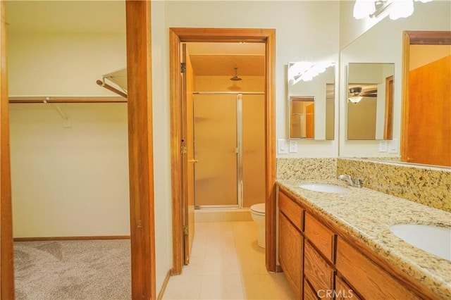 15084 Tacony Rd, Apple Valley, CA 92307 - full bathroom featuring double vanity, a stall shower, a spacious closet, toilet, and a sink
