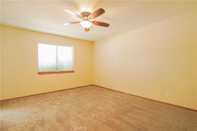 15084 Tacony Rd, Apple Valley, CA 92307 - empty room featuring light colored carpet, baseboards, and a ceiling fan