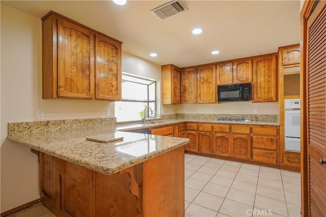 15084 Tacony Rd, Apple Valley, CA 92307 - kitchen with visible vents, oven, a sink, a peninsula, and black microwave