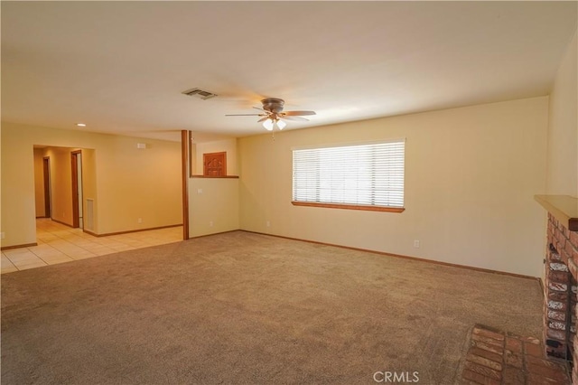 15084 Tacony Rd, Apple Valley, CA 92307 - unfurnished living room with baseboards, a stone fireplace, carpet flooring, visible vents, and ceiling fan