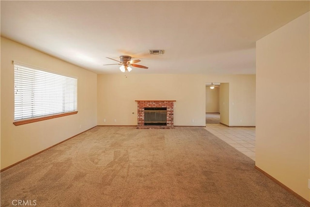 15084 Tacony Rd, Apple Valley, CA 92307 - unfurnished living room with ceiling fan, carpet floors, baseboards, a brick fireplace, and visible vents