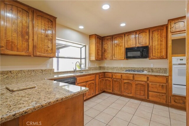 15084 Tacony Rd, Apple Valley, CA 92307 - kitchen featuring a sink, brown cabinetry, black appliances, and light stone counters