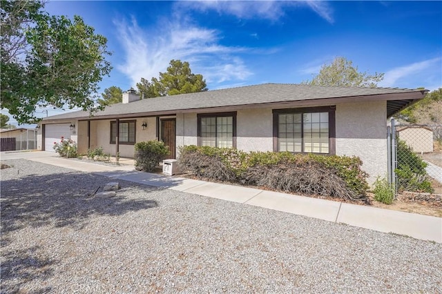15084 Tacony Rd, Apple Valley, CA 92307 - ranch-style house featuring a chimney, concrete driveway, fence, a garage, and stucco siding